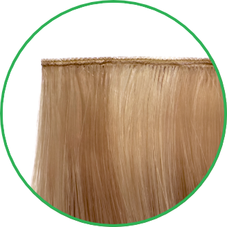 Blonde hair extension shown in a close-up on a white surface.