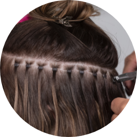 Hair stylist professional demonstrating a haircutting technique with scissors during training.
